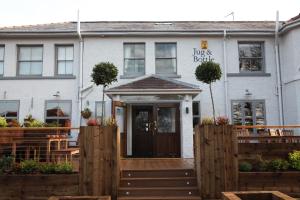 a house with a wooden fence in front of it at The Jug And Bottle in Heswall