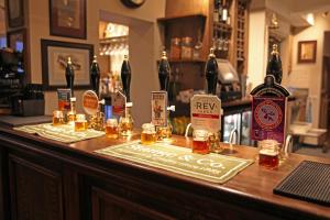 a bar with bottles of alcohol on a counter at The Jug And Bottle in Heswall