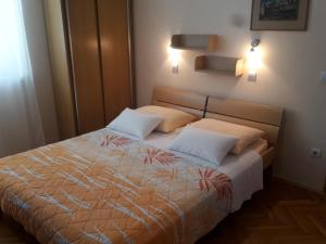 a bedroom with a bed with two white pillows at Apartments Kurtic in Makarska