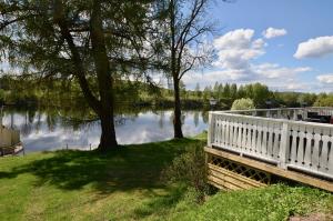 a bridge over a body of water with trees at Husby Wärdshus in Dala Husby