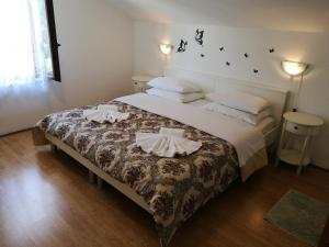 a bedroom with a large bed with two pillows at Villa Radovic in Cavtat