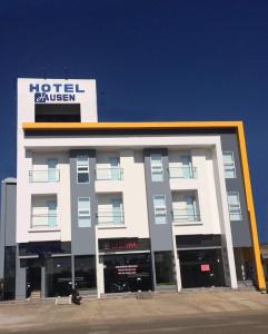 a building with a hotel driven sign on top of it at Hotel Hausen in Lorica