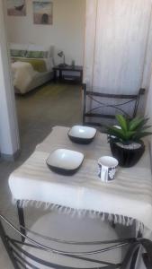 a table with two plates and a plant on it at Self-catering Studio, Unit 6 on Krupp in Windhoek