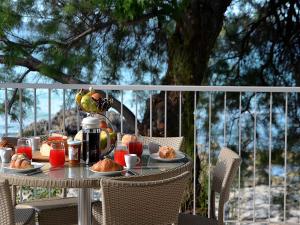 a table with plates of food on a balcony at Luxury Beach Villa Puglia Italy in Pulsano