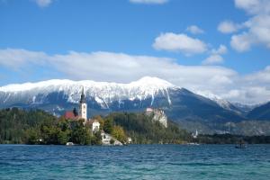 a castle on an island in the middle of a body of water at Apartment April in Bled