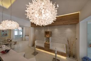 a living room with two chandeliers at Artemide Hotel in San Vito lo Capo