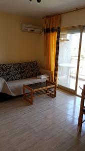 A bed or beds in a room at Apartamentos Olympia Center