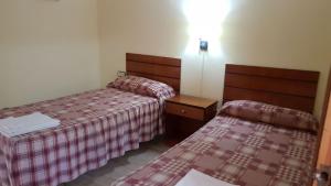 A bed or beds in a room at Apartamentos Olympia Center