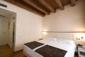 Uma cama ou camas num quarto em Albergo Mazzanti