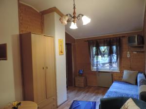 a living room with a blue couch and a window at Western Penzion in Ružomberok