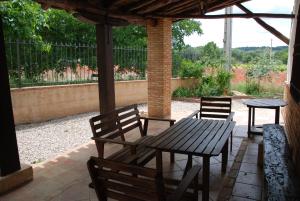 a wooden table and chairs under a pavilion at Casa del Rio in Villanueva de la Jara +42 photos