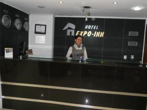 a man standing at the counter of a hotel expo inn at Hotel Expo Inn Embajada in Bogotá