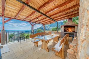 an outdoor patio with a table and a fireplace at Holiday Home Marincello in Solin