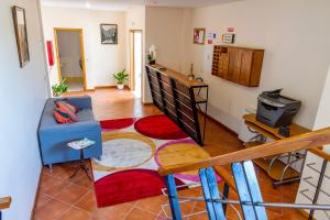 a living room with a couch and a tv at Hostel Carvalho in Mondim de Basto