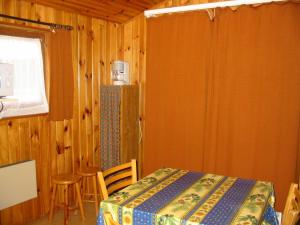 a room with a table and chairs and a window at Camping du Meygal in Saint-Julien-Chapteuil