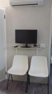 two white chairs in front of a computer monitor at Campeggio Amici di Lazise in Lazise