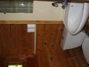 a bathroom with a urinal and a sink and wooden walls at Camping du Meygal in Saint-Julien-Chapteuil +28 photos