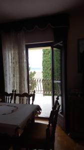 a bedroom with a bed and a large window at Guesthouse Galimar in Crikvenica