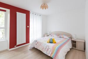 Dormitorio blanco con cama y pared roja en Corneille by Cocoonr en Rennes