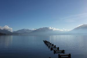 a row of docks in the middle of a lake at Centre Jean XXIII in Annecy