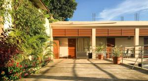 a building with plants and flowers in front of it at La Casa Del Italiano in Tarapoto