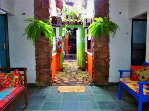 a hallway in a house with palm trees at Aracy Paraty in Paraty