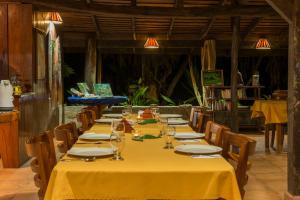 a long table in a restaurant with yellow table cloth at Tiskita Jungle Lodge in Pavones