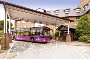 a bus is parked in front of a building at Premier Inn London Gatwick Airport - A23 Airport Way in Horley