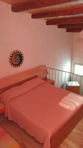 a bedroom with a red bed and a mirror on the wall at Casa Maruzza in Donnalucata