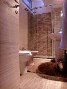 a bathroom with a toilet and a sink and a shower at Casa Antonella in Letojanni