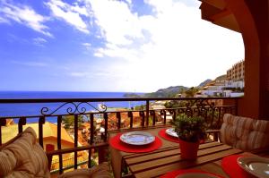 a balcony with a table with a view of the ocean at Casa Antonella in Letojanni
