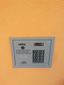 a digital clock on an orange wall at Zamość przy Starówce in Zamość