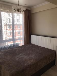 Кровать или кровати в номере Apartment on ulitsa Volzhskaya 34
