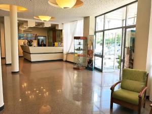 an empty lobby with a chair and a store at Hotel River Palace in Terracina +23 photos