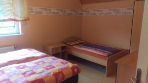 a small bedroom with two beds and a window at Ferienhaus Bornscheuer in Gerstungen
