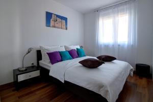 A bed or beds in a room at Apartments Maris Senj