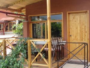 a house with a porch with a glass door at Hotel Utz Jay in Panajachel