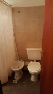 a bathroom with a white toilet and a bidet at Los Colorados Hostal in Angastaco