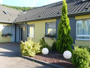 a house with two white balls in front of it at Hotel Premium in Forbach