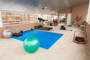 a gym with a large blue yoga ball on the floor at Jacques Georges Tower in Pelotas