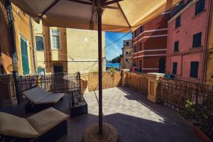 a patio with an umbrella and chairs on a balcony at Hotel Pino in Lerici