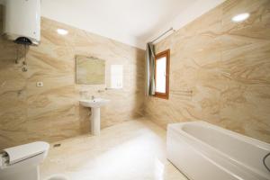 a bathroom with a sink and a tub and a toilet at Apartmani Svetionik in Budva +25 photos