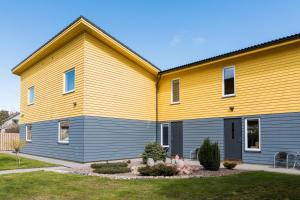 a house with a yellow at Vila Paulina in Palanga