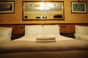 מיטה או מיטות בחדר ב-Cricklewood Lodge Hotel