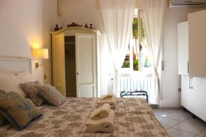 a bedroom with a bed with two towels on it at Soggiorno Tagliaferro in Marciana Marina