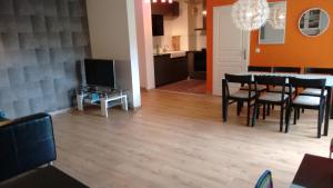 a dining room and living room with a table and chairs at lille grand boulevard in Marcq-en-Baroeul