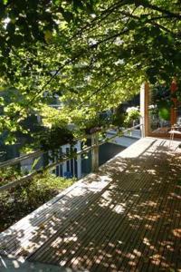 a tree casts a shadow on top of a fence at Aparthotel Malpertuus in Aalst