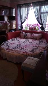 a bedroom with a large bed with a window at Apartment on Raisy Okipnoi 5 in Kyiv