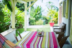a table with a striped table cloth on a porch at villa telyna in Trois-Rivières