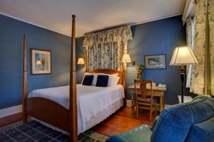 a bedroom with a bed and a desk in a room at Brown Street Inn Bed and Breakfast in Iowa City